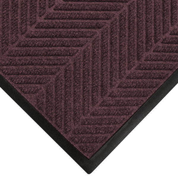 A maroon WaterHog mat with black trim.