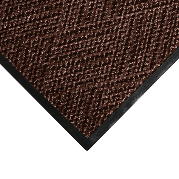 A brown M+A Matting WaterHog doormat with black trim.