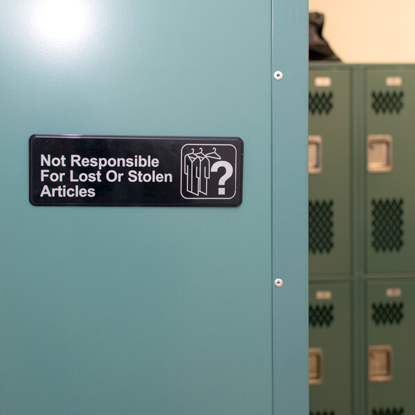 A black and white Thunder Group sign on a wall that says "Not Responsible for Lost or Stolen Articles"