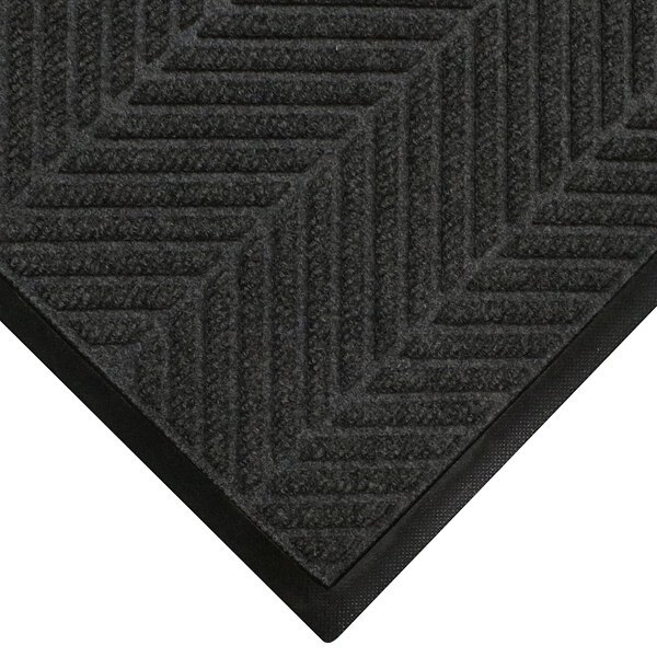 A close-up of a black WaterHog mat with a chevron pattern.