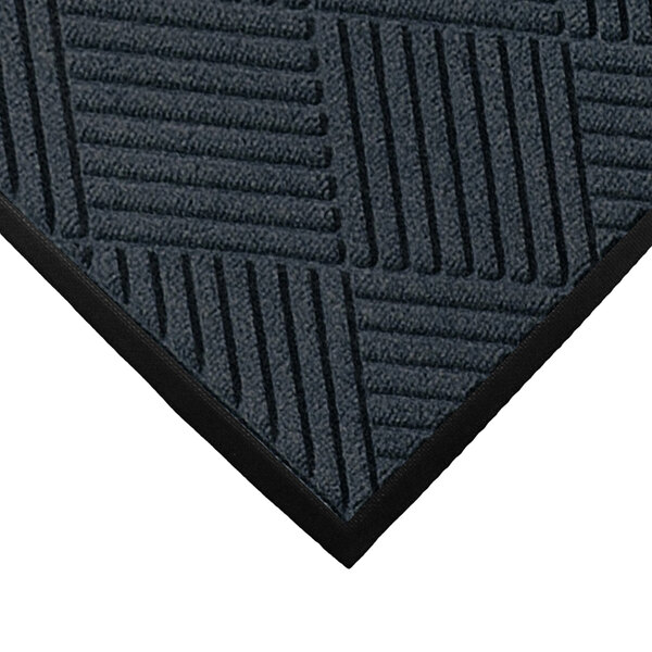 A close-up of a M+A Matting WaterHog Charcoal mat with a diamond pattern.