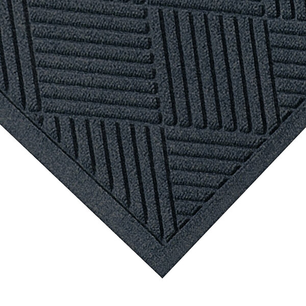 A close-up of a M+A Matting WaterHog Diamond Fashion charcoal mat with a pattern of squares.