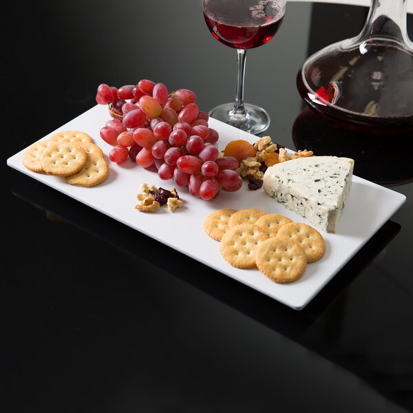 An American Metalcraft white flat melamine platter with cheese, crackers, and a glass of wine.
