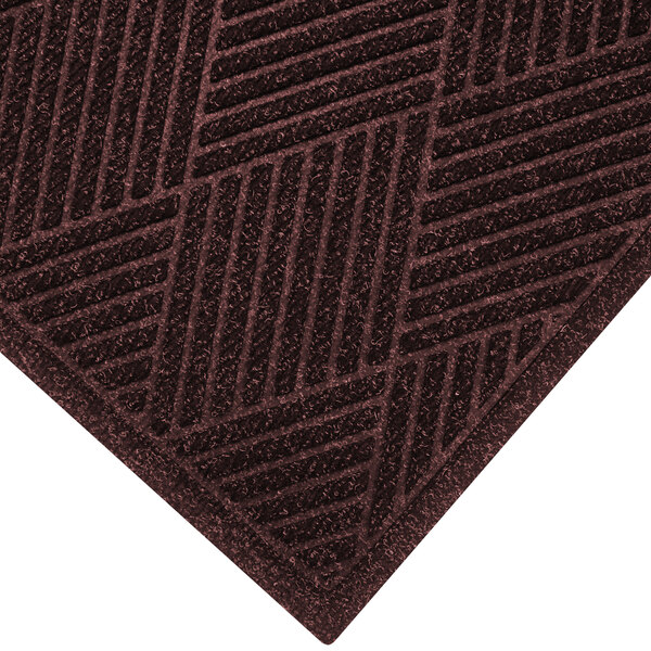 A maroon WaterHog doormat with a patterned border.