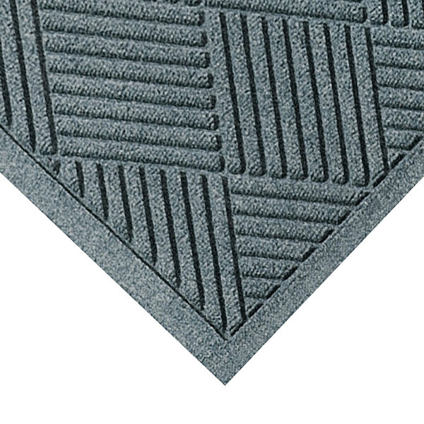 A close-up of a grey M+A Matting WaterHog Diamond Fashion carpet with a pattern of squares.