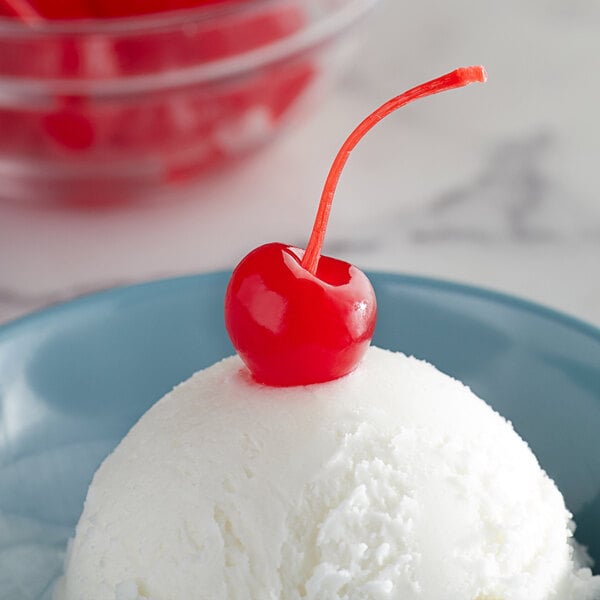 A scoop of white ice cream with a Regal Maraschino Cherry on top.