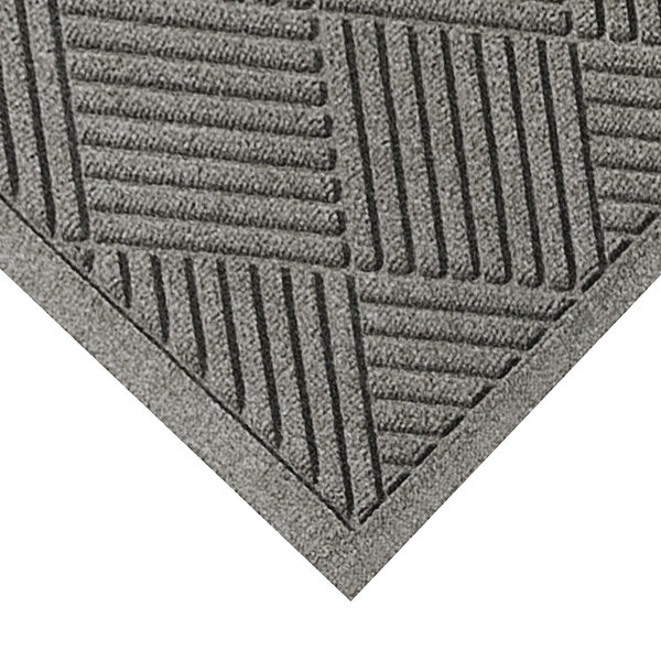 A close-up of a grey WaterHog mat with a square pattern.