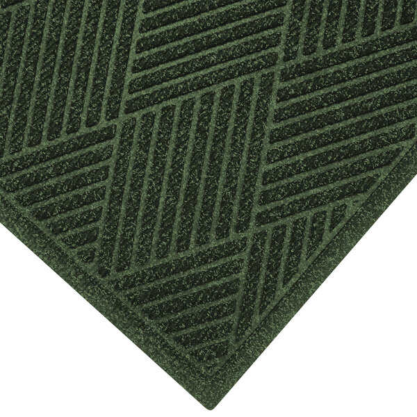 A green WaterHog entrance mat with a square pattern and fabric border.