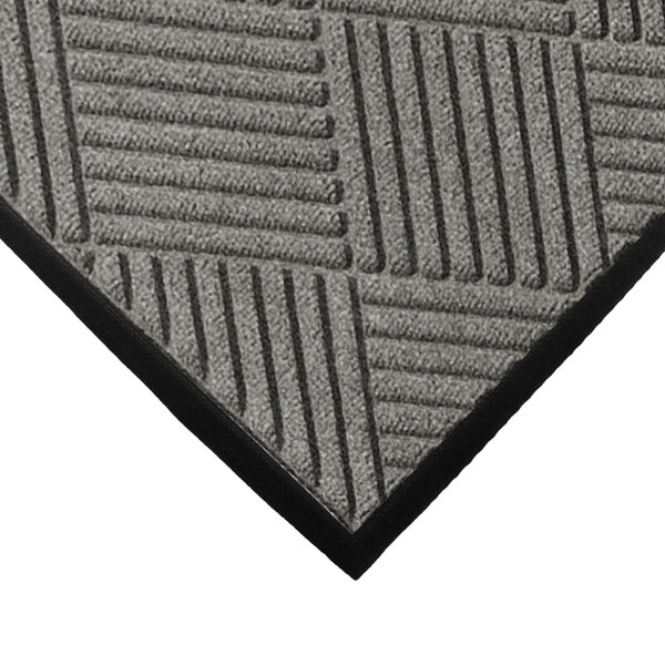 A close-up of a grey WaterHog mat with a diamond pattern and black rubber border.