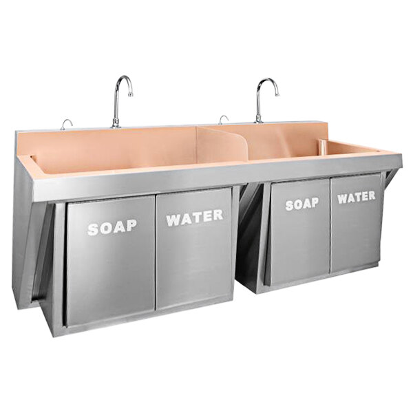 A Just Manufacturing wall-hung copper double bowl scrub sink with knee-operated faucets and soap valves.