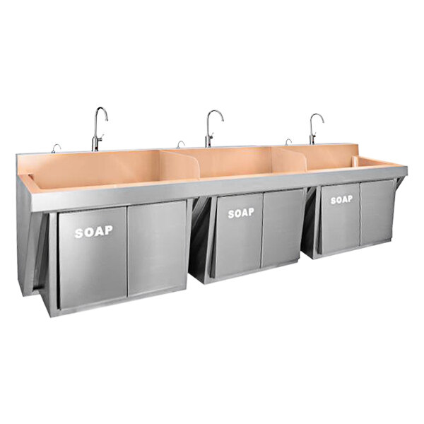 A Just Manufacturing copper wall-hung triple bowl scrub sink with sensor faucets and knee operated soap dispensers.