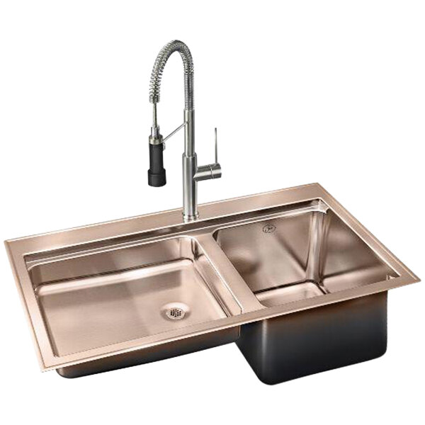 A Just Manufacturing copper drop-in sink with two faucets.