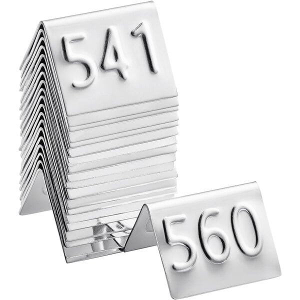 A stack of American Metalcraft stainless steel table tents with the number 551.