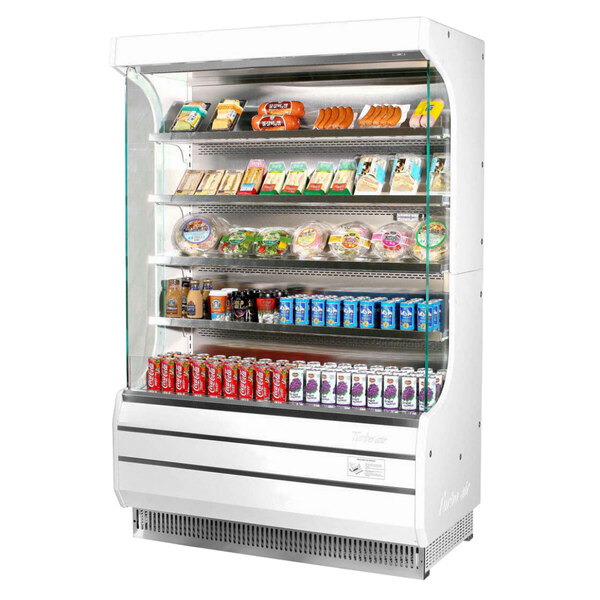A white Turbo Air air curtain merchandiser with food and drinks on shelves inside.