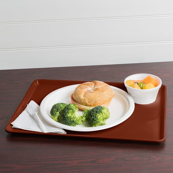 A Cambro dietary tray with a sandwich, broccoli, and bread.