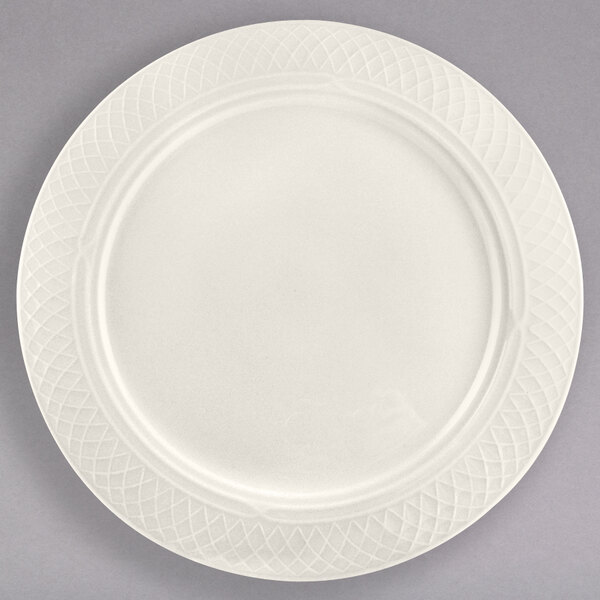 A Homer Laughlin ivory china plate with a circular pattern on the edge.