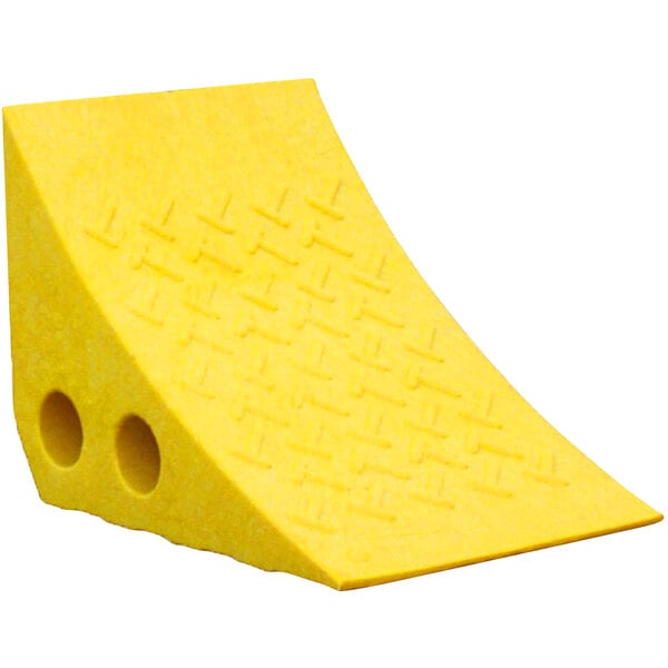 A yellow plastic wheel chock with holes in it.
