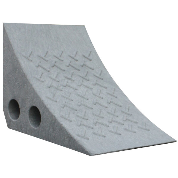 A gray plastic wheel chock with holes in it.