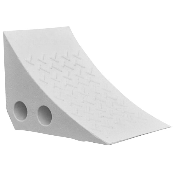 A white plastic wheel chock with holes in it.