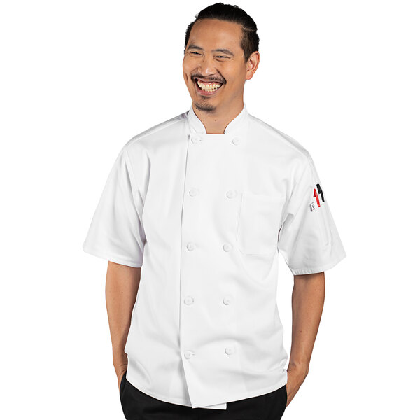 A man in a white Uncommon Chef short sleeve chef coat with Tingo embroidery smiling.