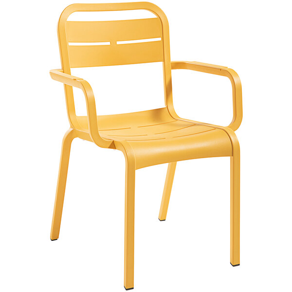 A pack of 4 yellow Grosfillex outdoor armchairs with armrests.