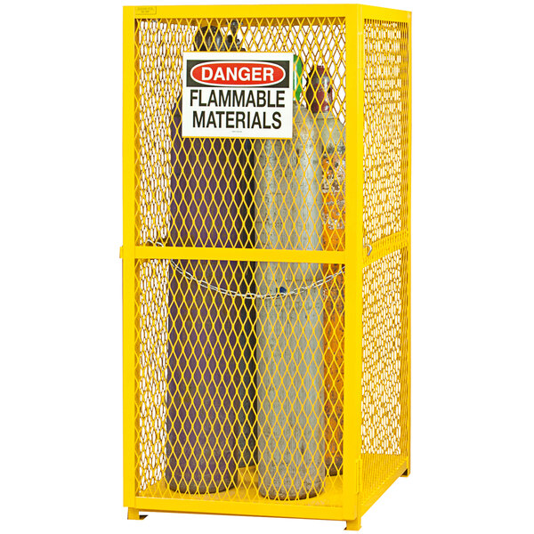 A yellow metal mesh Durham gas cylinder cabinet with a sign on it.