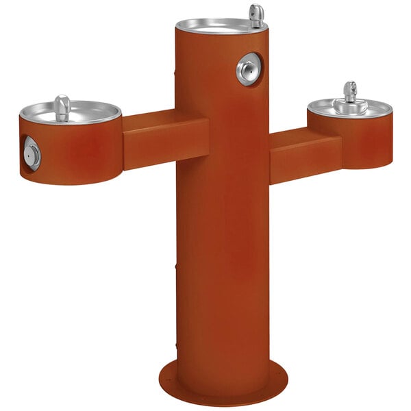 A red metal Halsey Taylor outdoor pedestal drinking fountain with three spouts.