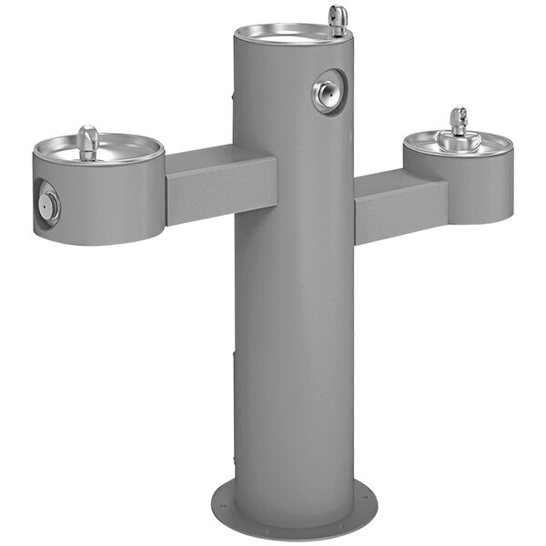 A gray metal Halsey Taylor outdoor tri-level pedestal drinking fountain with three spouts.