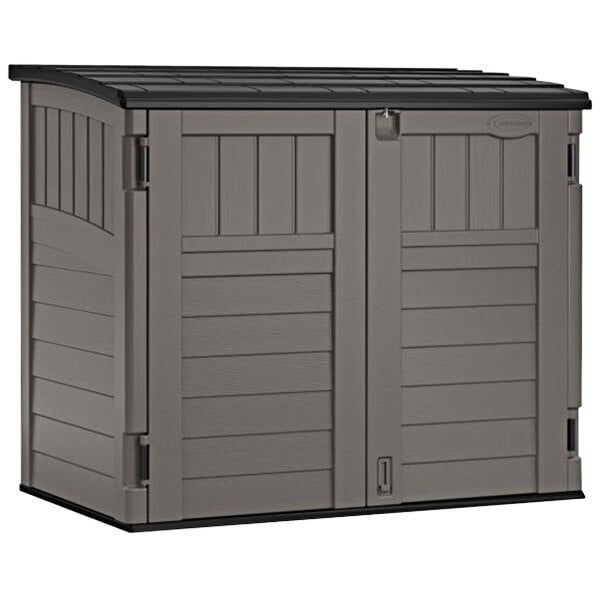 A grey plastic Suncast horizontal storage shed with a black top.
