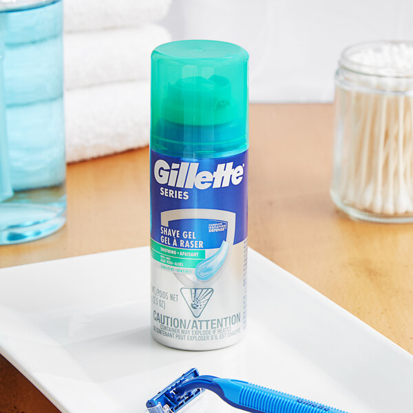 A bottle of Gillette Series Men's Sensitive Shave Gel with Aloe on a white plate.