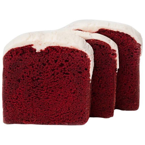 A close up of a red velvet cake with white frosting.