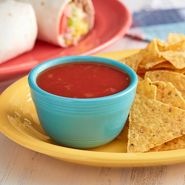 A plate of tortilla chips with Pace Mild Picante Sauce.