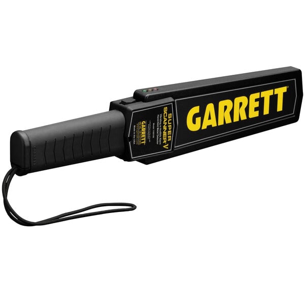 A black Garrett handheld metal detector with yellow text.