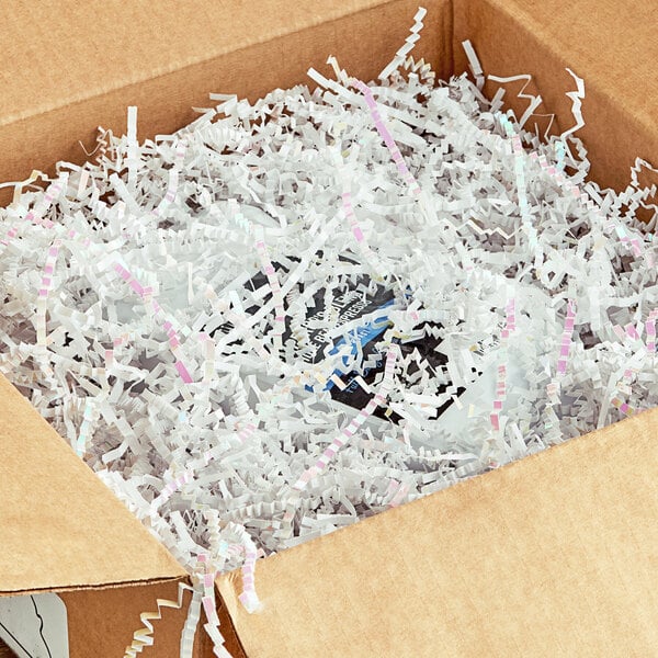 A cardboard box with Spring-Fill White Radiance Crinkle Cut paper shred inside.