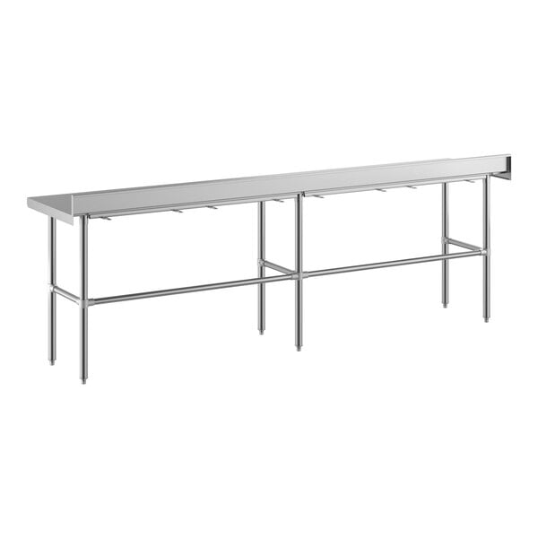 A long, rectangular stainless steel work table with an open base, four legs, and a 4-inch backsplash along the back edge.