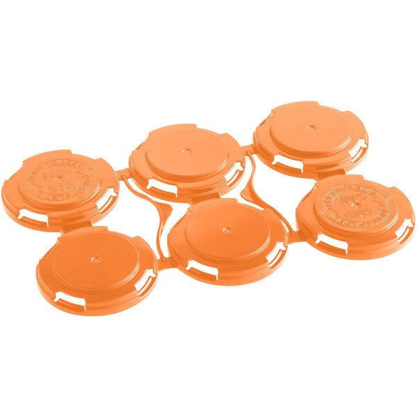 A close-up of an orange plastic PakTech carrier with six circles.