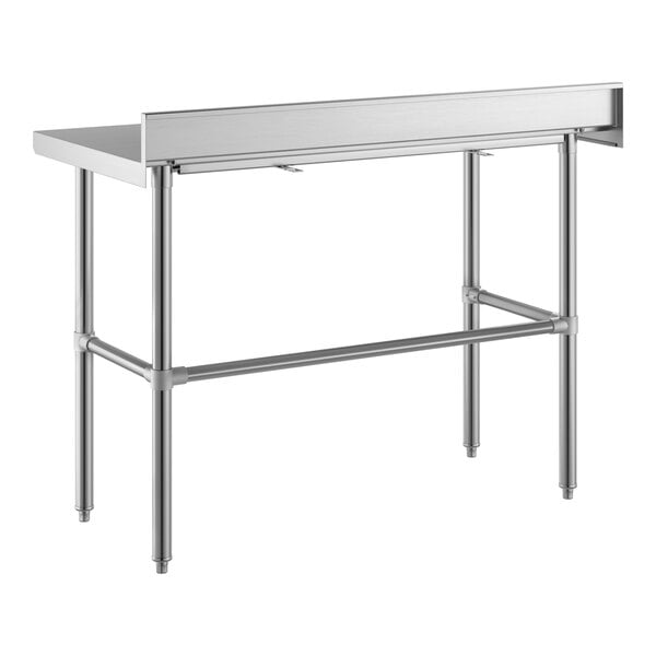 A stainless steel table with an open base, four legs, and a raised backsplash along the back edge.