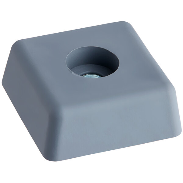 A gray square door switch activator with a hole in it.