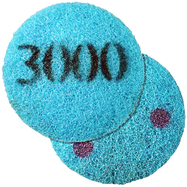 A blue sponge with a purple circle and black text that says "Onfloor 282138 6 1/2" Poly Pad with 3,000 Grit"