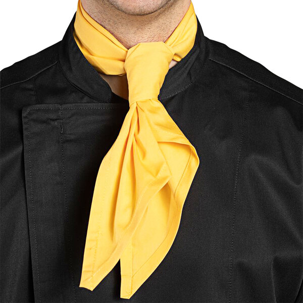 A man wearing a Uncommon Chef sunflower neckerchief around his neck.