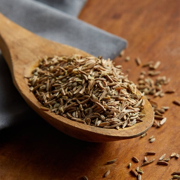 A wooden spoon filled with Regal caraway seeds.