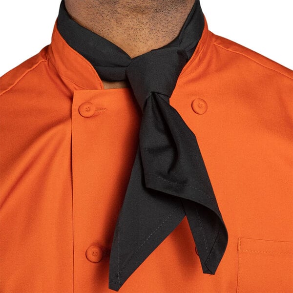 A person wearing a black Uncommon Chef neckerchief around their neck.