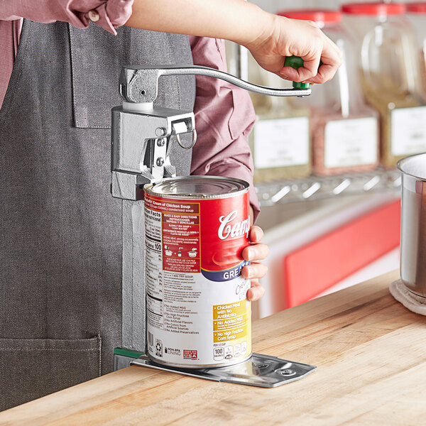 A person using a Garde Heavy-Duty NSF Manual Can Opener on a can of food.
