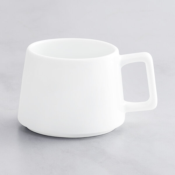 A close-up of a white Oneida Scandi porcelain espresso cup with a handle.