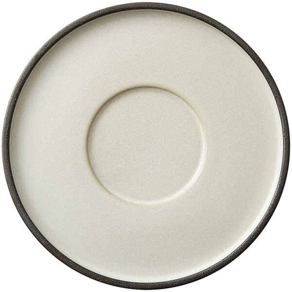 A close-up of a white Oneida Moira stoneware saucer with a black rim.