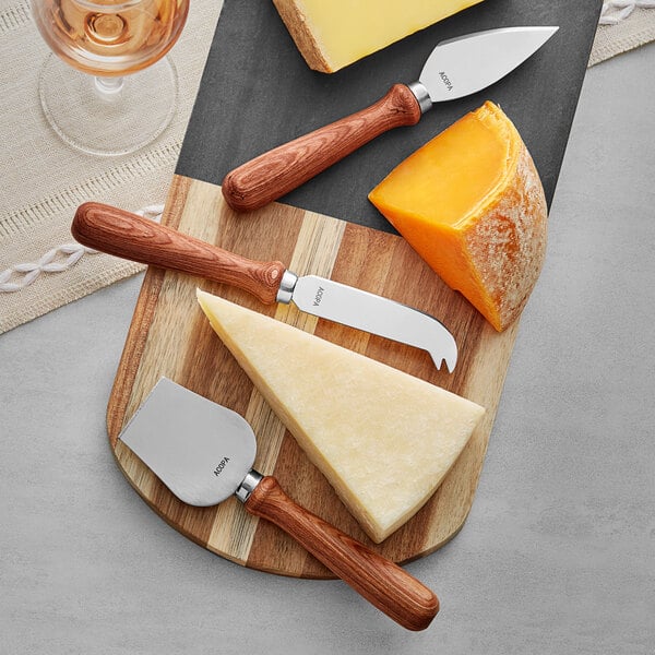 A cheese knife with a wooden handle next to a wedge of cheese on a cutting board.