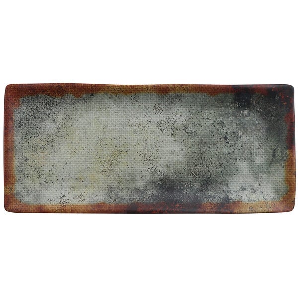 A cheforward rectangular woven melamine plate with a rusted edge.