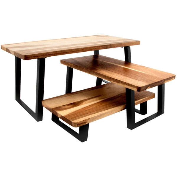 A GET wood riser with foldable metal legs on a wooden table.