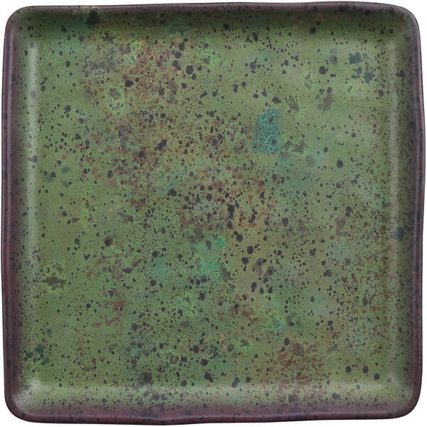 A white cheforward by GET Savor square melamine plate with green and black specks.