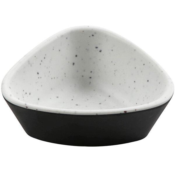 A white bowl with black speckles.